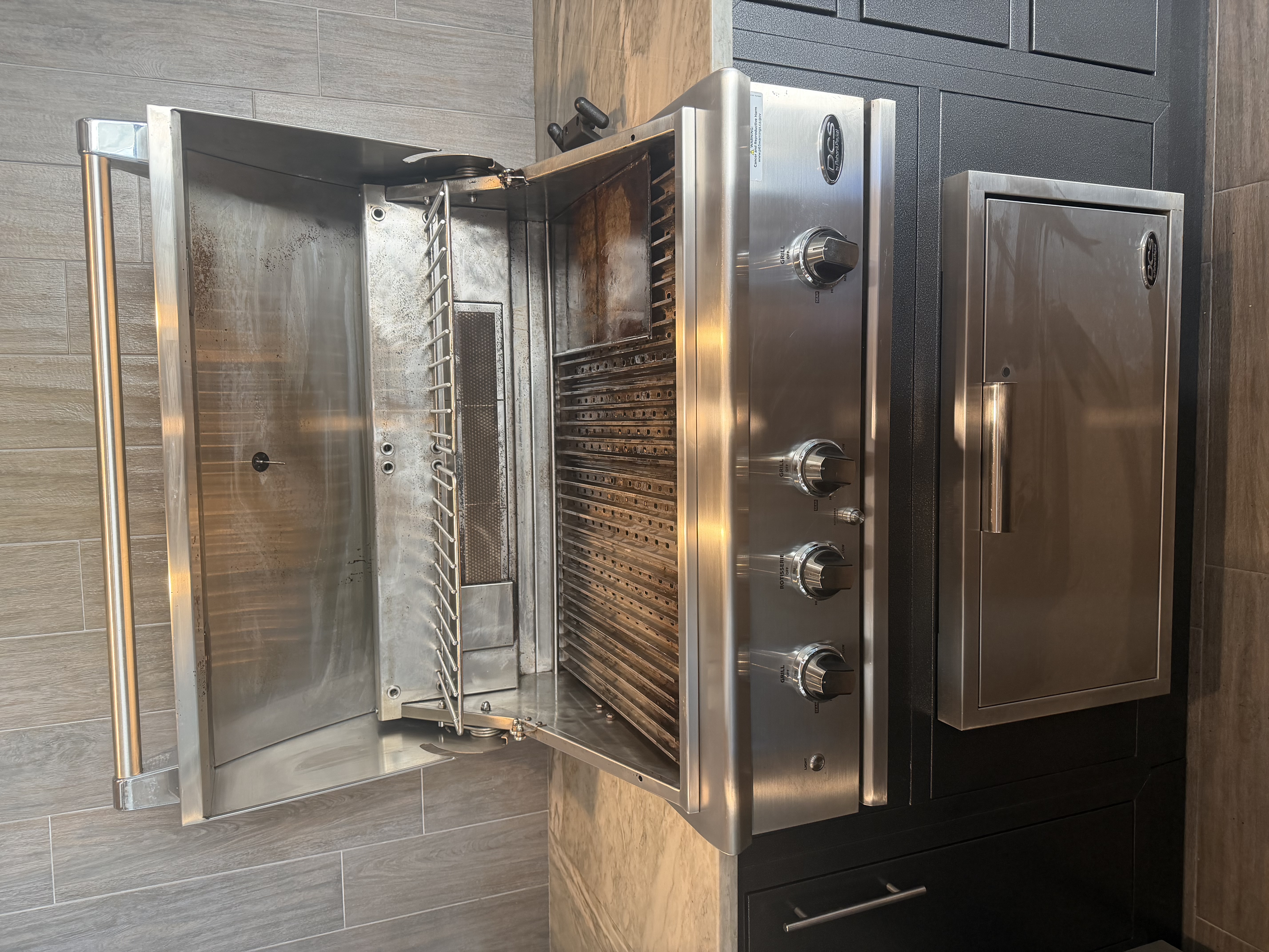 After: the same DCS 4-burner built-in with a polished stainless cookbox and a clean control panel