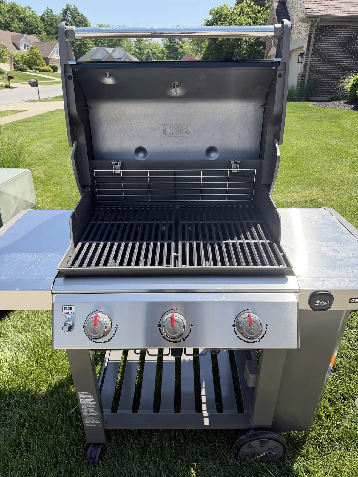 After: the same Weber Genesis II 3-burner with clean grates reinstalled, a polished cookbox interior, and a clear control panel