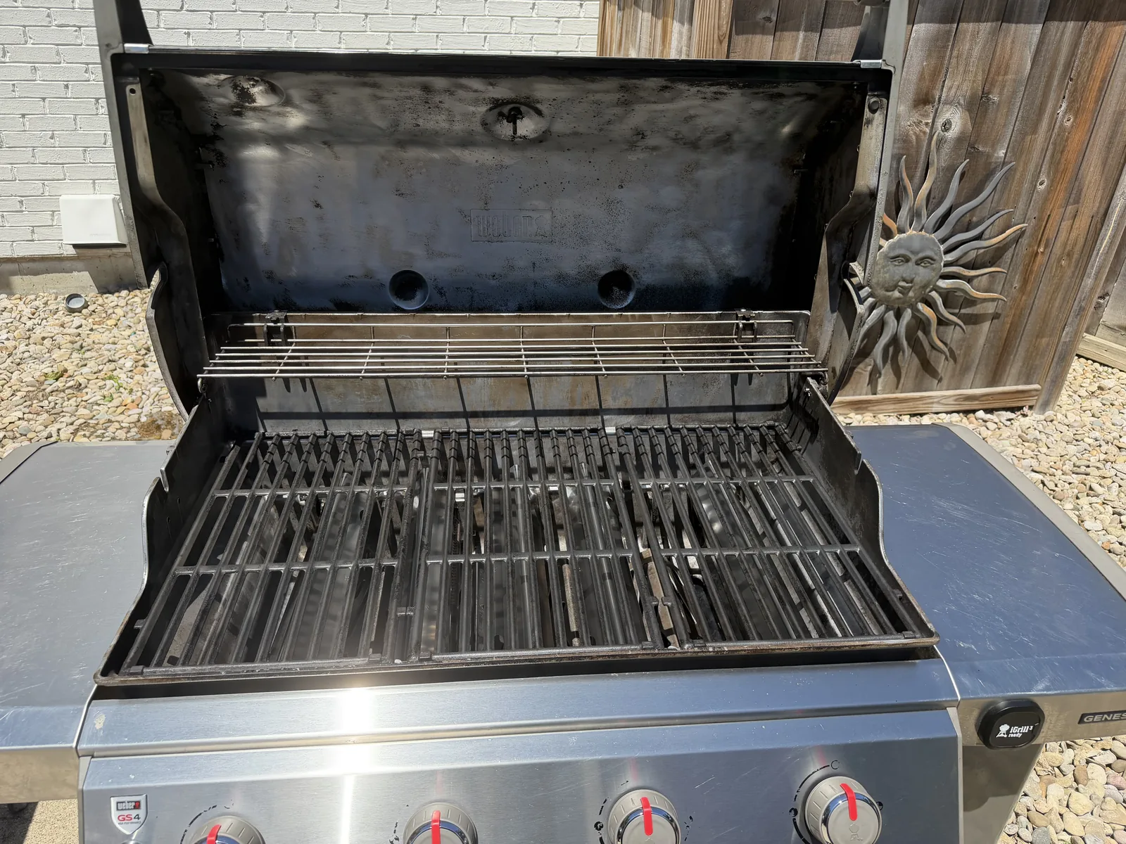 After: the same Weber Genesis II with clean grates reinstalled and a wiped-down cookbox, ready to cook